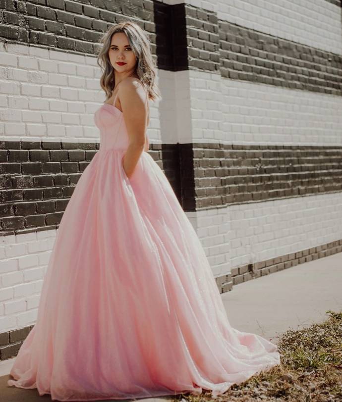 Model wearing a pink prom collection gown